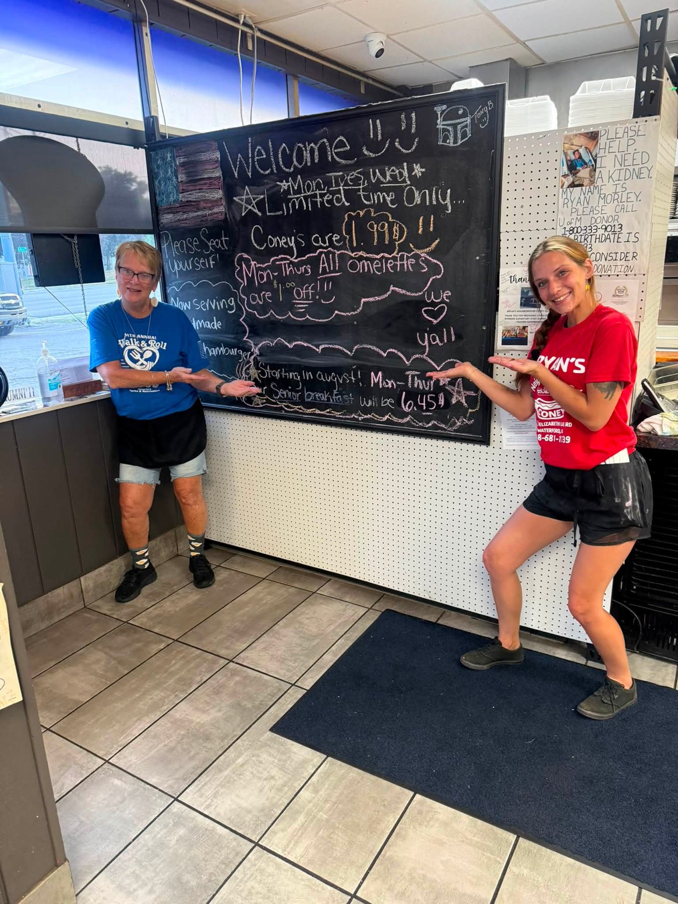 Crew posing by the welcome chalkboard