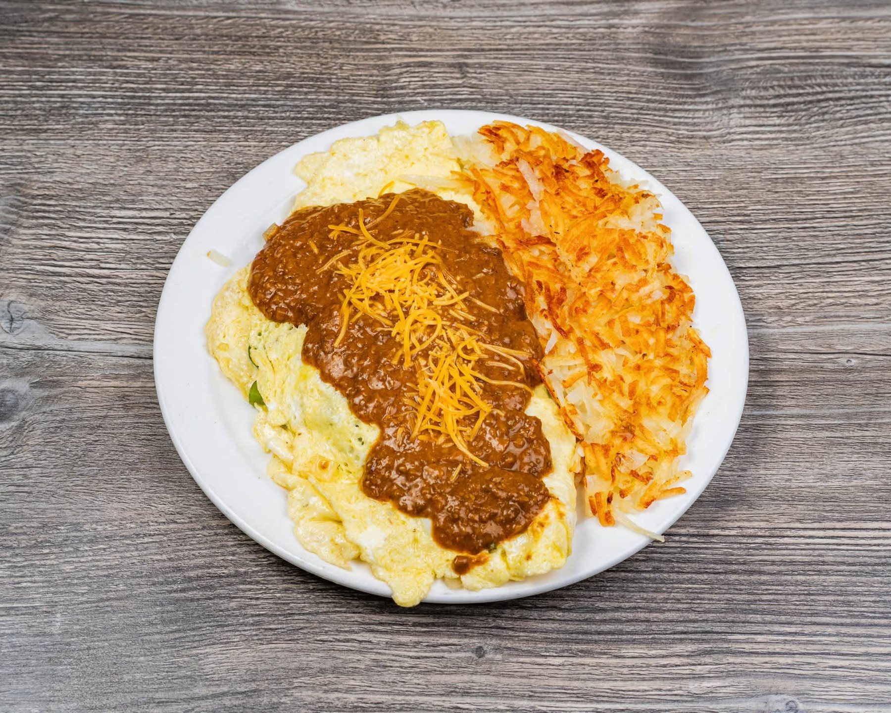 Omelette topped with coney chili and cheese with hash browns