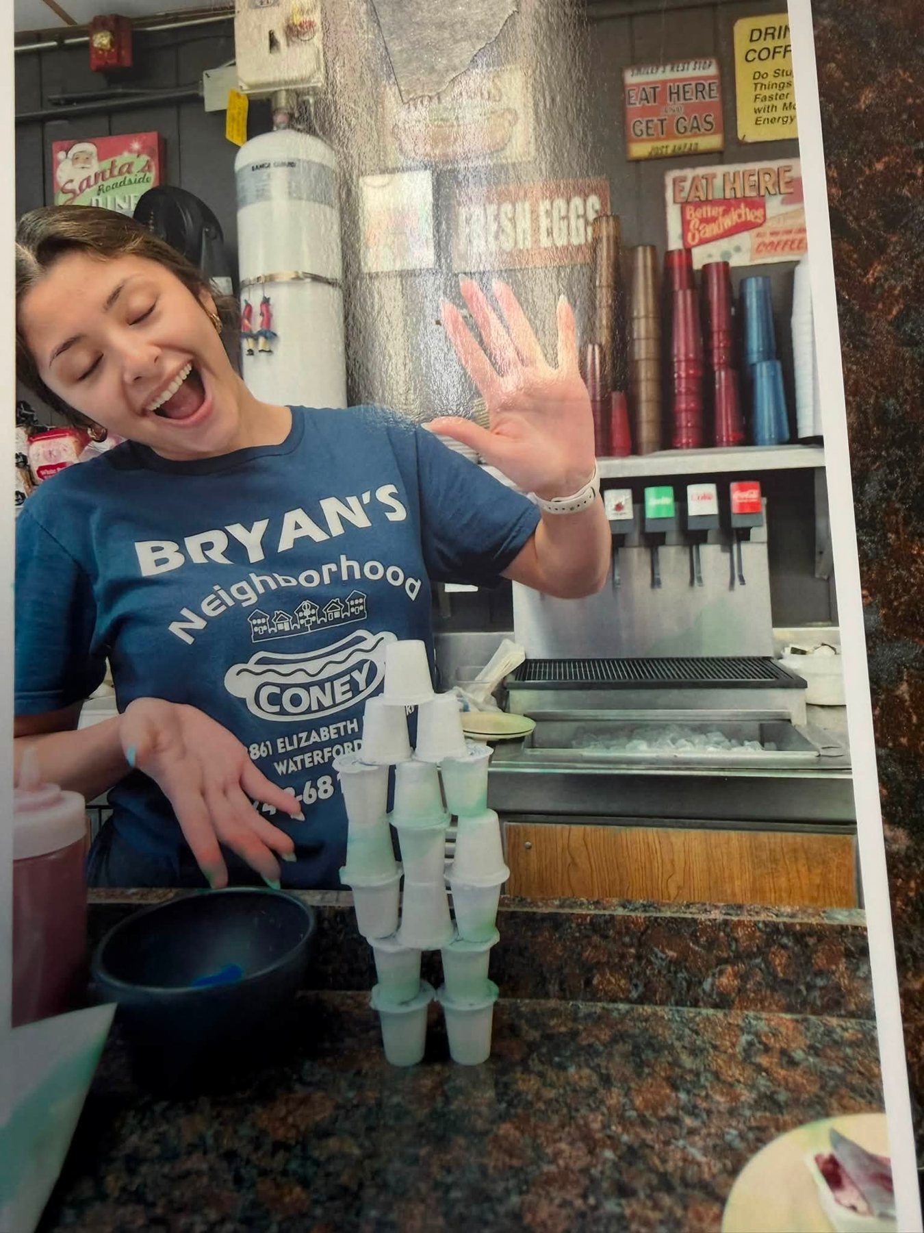 Server waving behind the counter